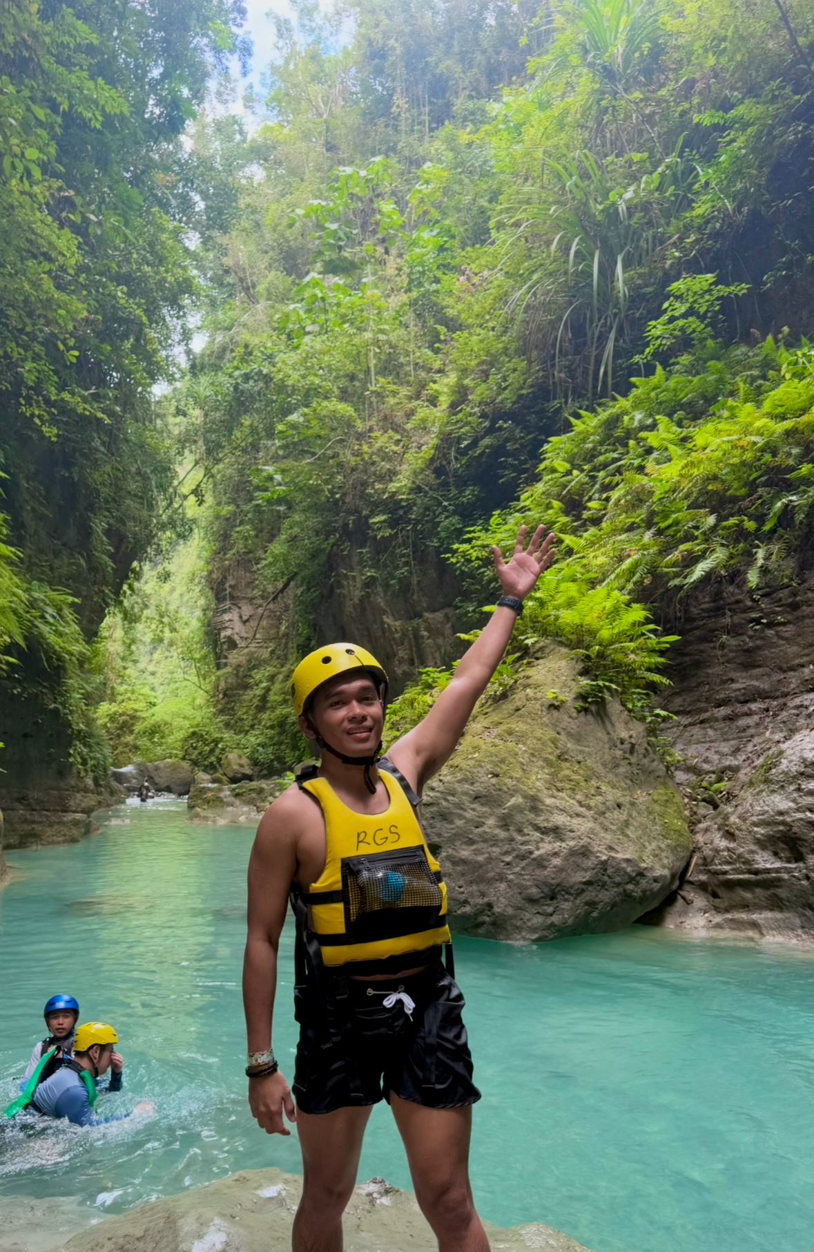 Froyows trying the canyoneering in Badian Cebu wearing yellow vest and safety hat