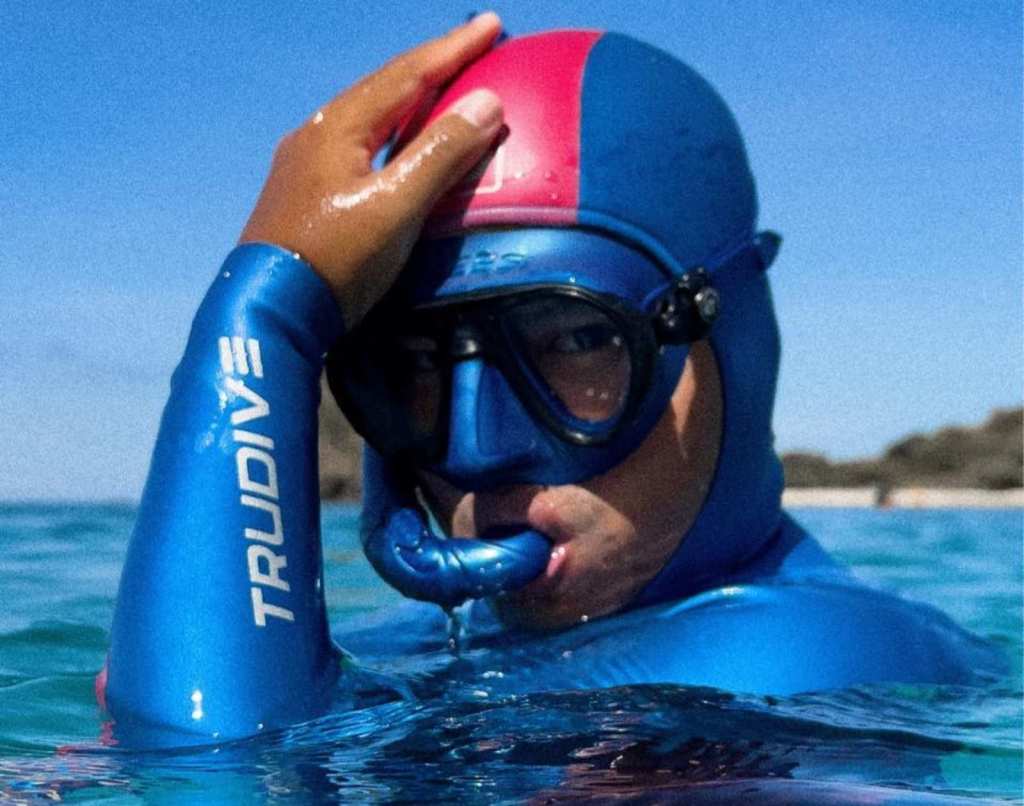 Coach Pilyo wearing a blue TruDive wet suit with a blue snorkel mask